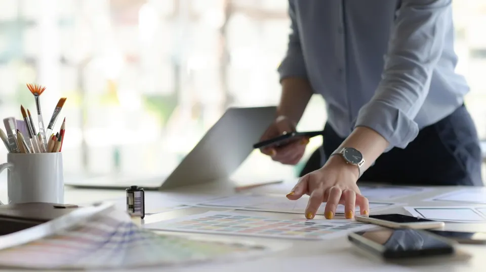 Midsection Of Woman Working At Table