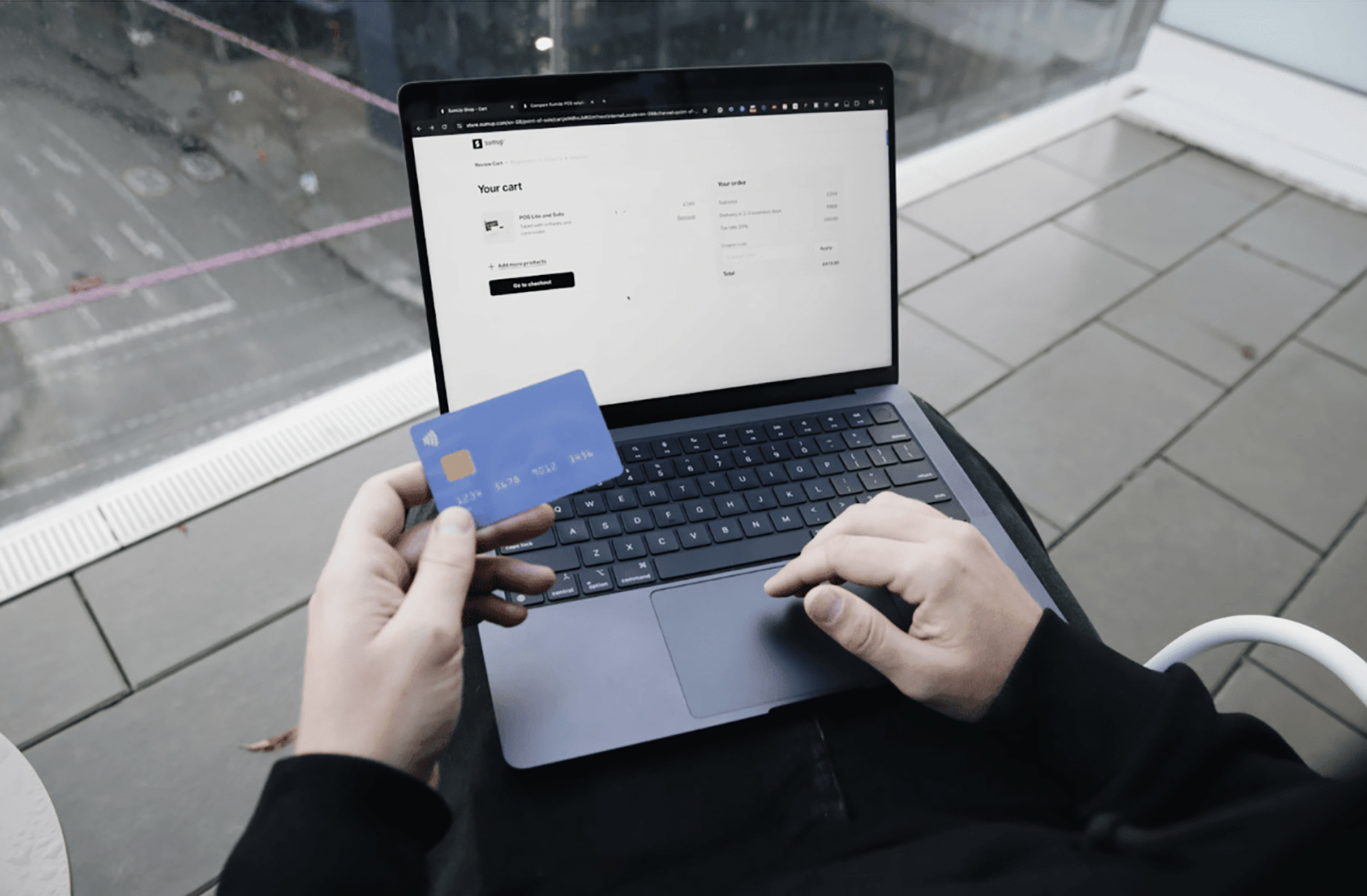 A person types their bank details into a window browser.