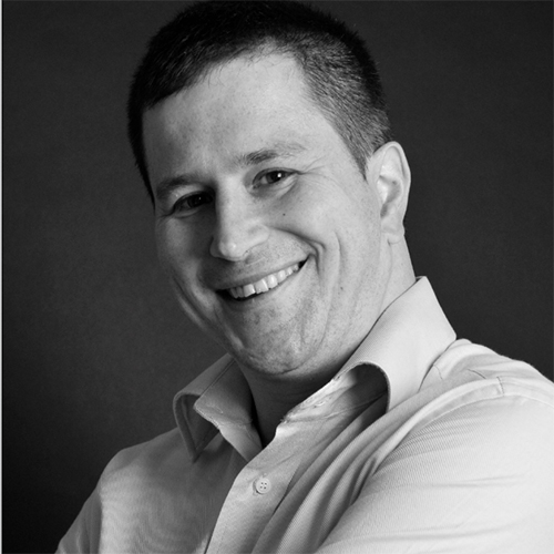 A headshot of the journalist Tom May. 