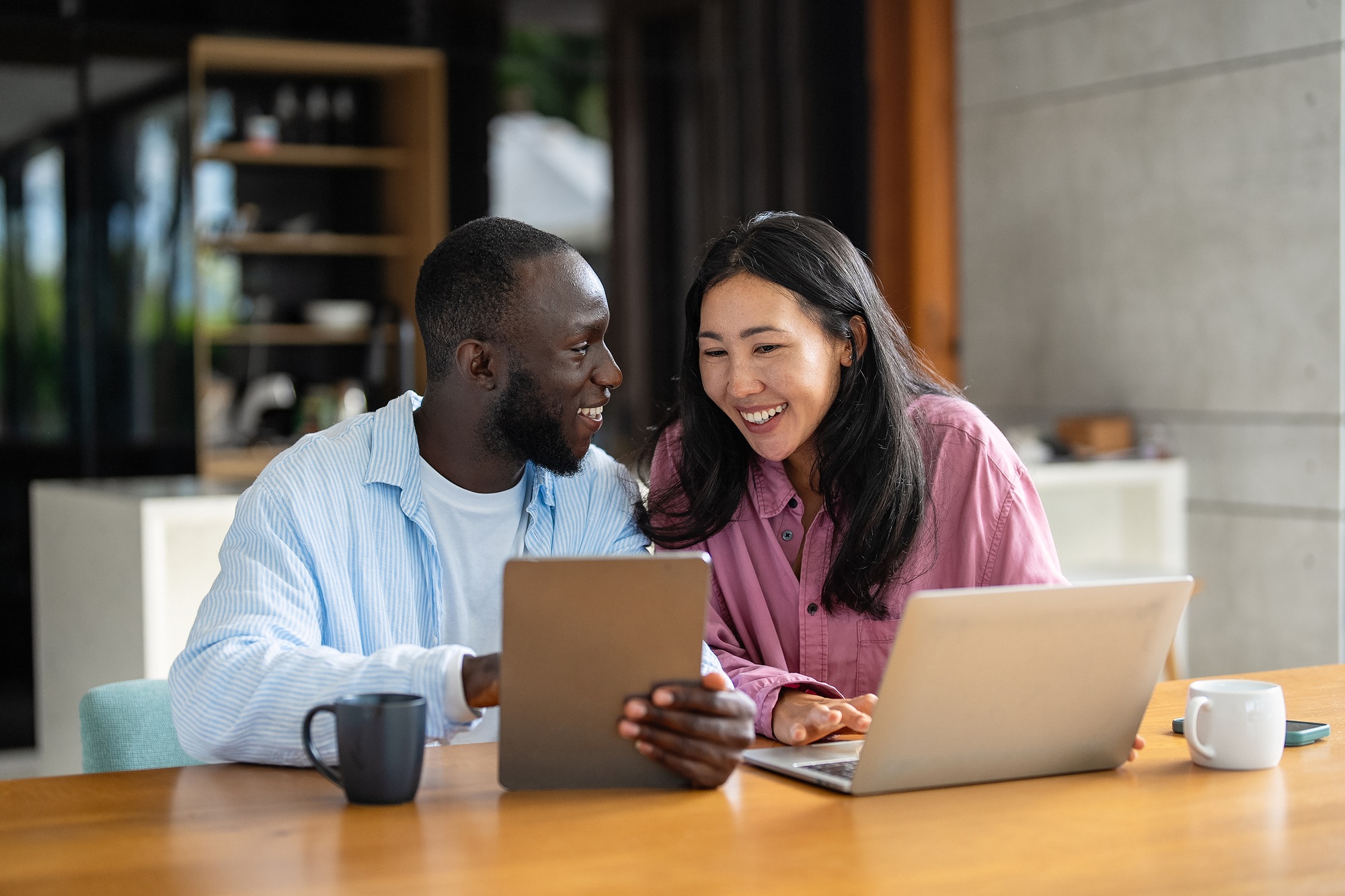 Digital lifestyle, online connectivity. Diverse couple enjoying entertainment shopping with laptop
