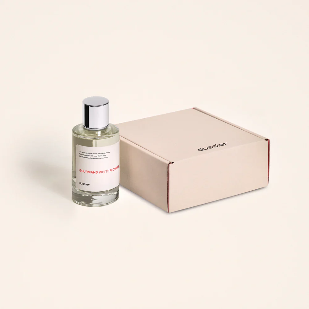 Gourmand whiteflowers perfume sits next to a branded Dossier box