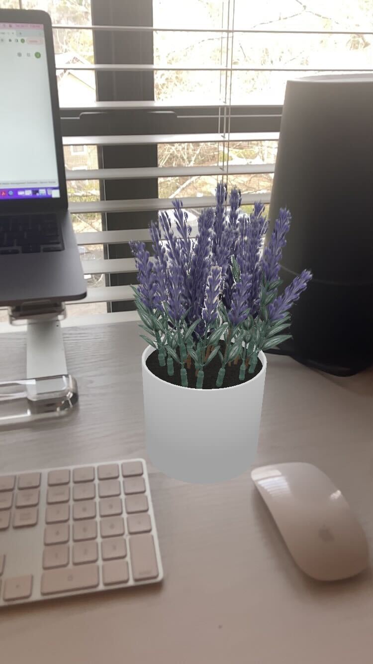 Screen capture of Target's See It in Your Space augmented reality feature. An AR flowerpot rest on a desk. 