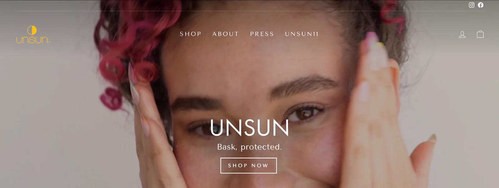 Unsun Cosmetics’ website shows a model with pink-tinged hair applying its skin protection.