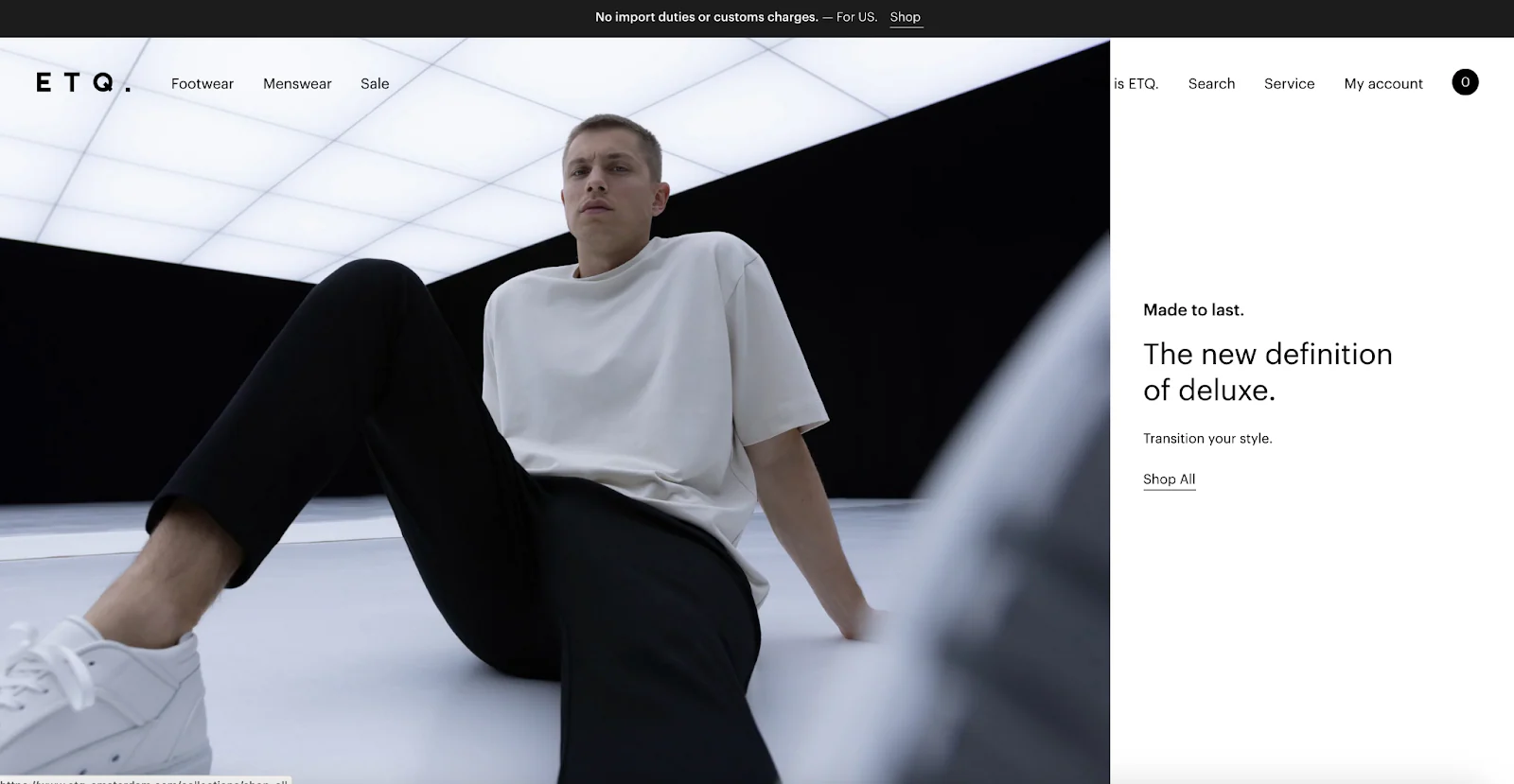 ETQ Amsterdam homepage with a model in black pants and a white shirt.