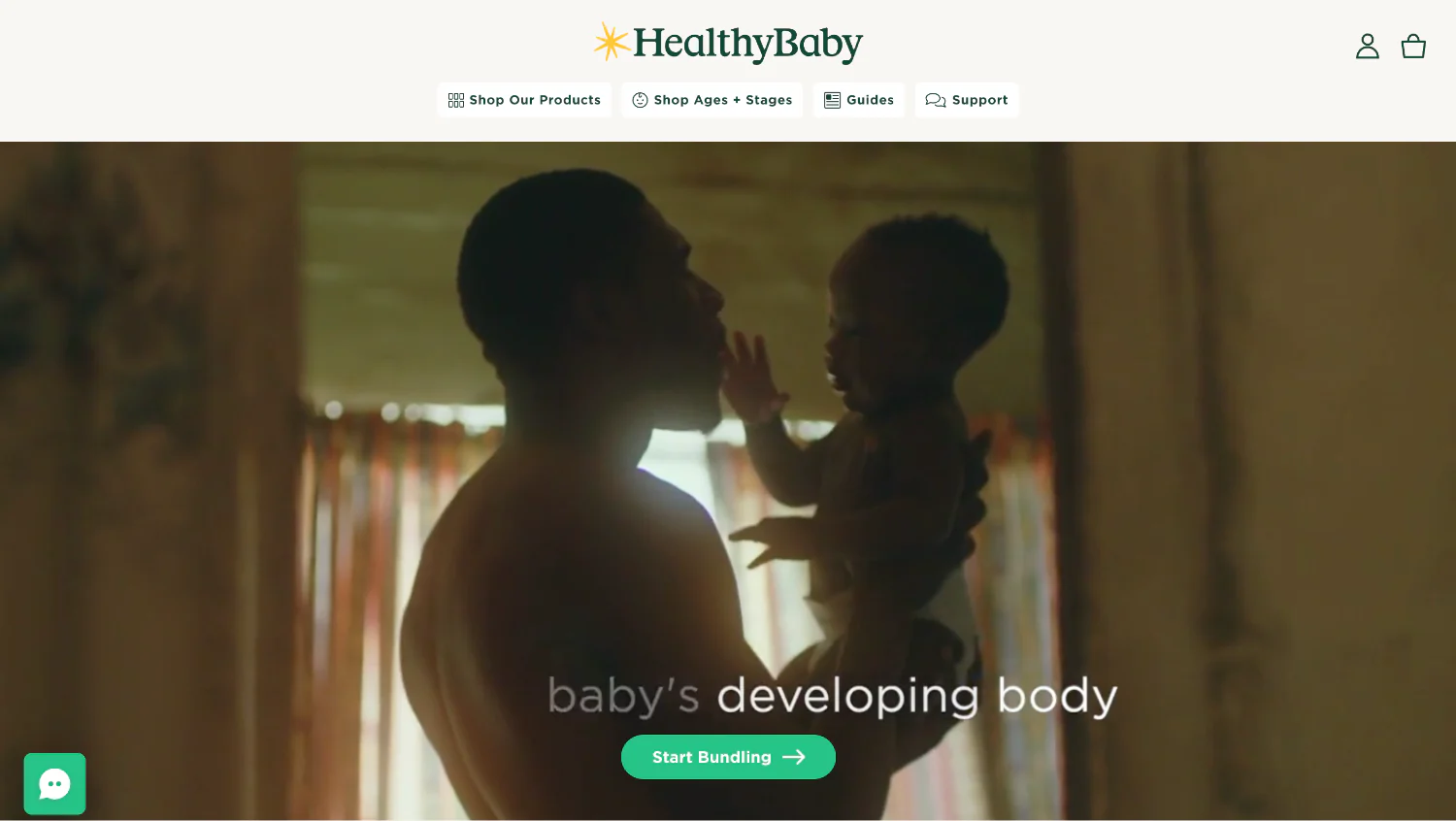HealthyBaby homepage with dad holding a baby in warm lighting with ’Start Bundling’ button.