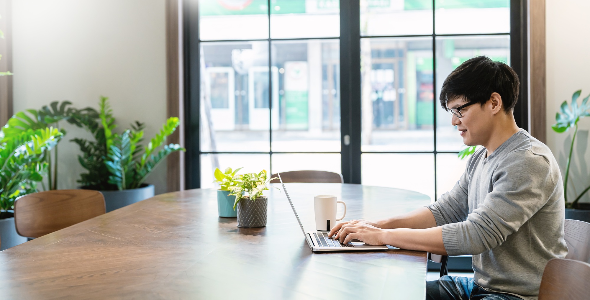 Portrait of smiling business asian glasses nerd man working office desk virtual computer