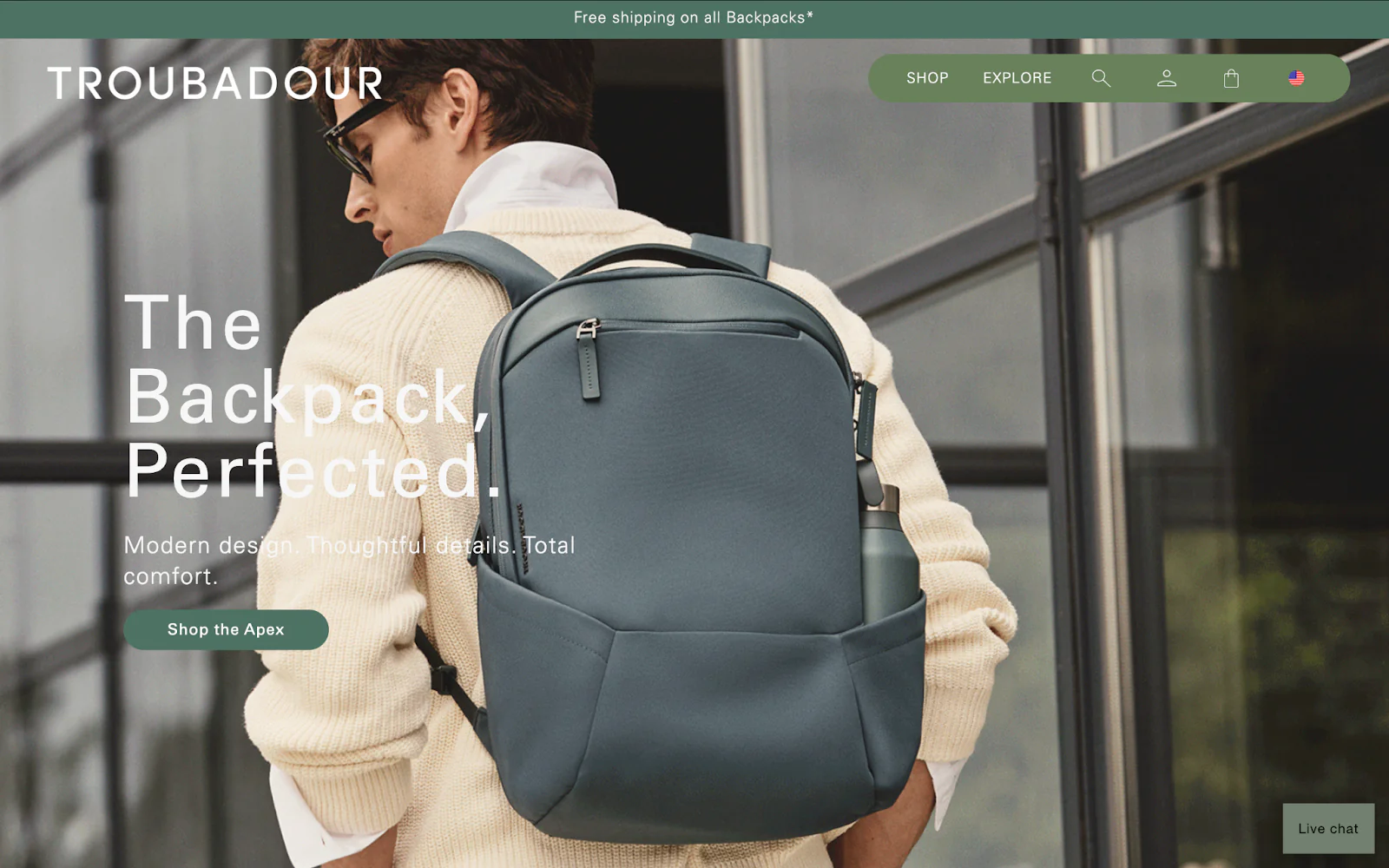 Troubadour backpack website with horizontal promo element and pill-shaped green navigation bar.
