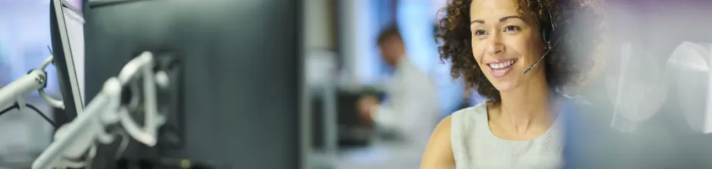 woman wearing a headset working on a computer science degree