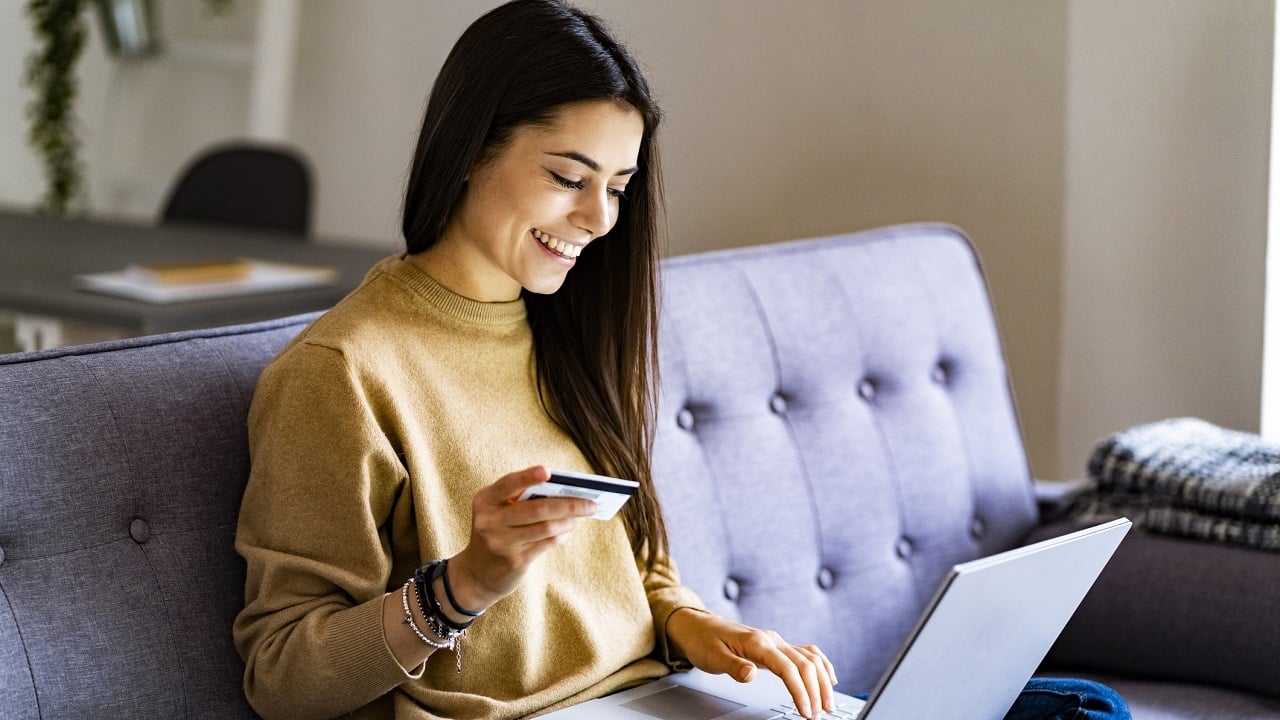 person shopping online using a credit card