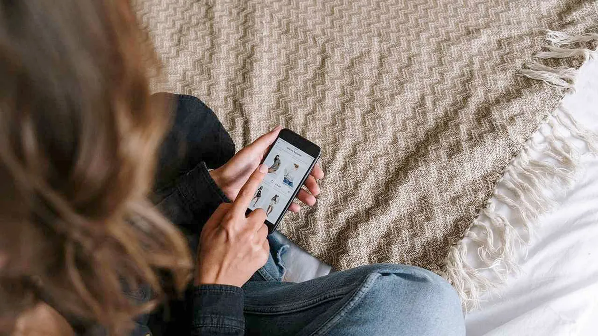 A woman shopping online on her phone.