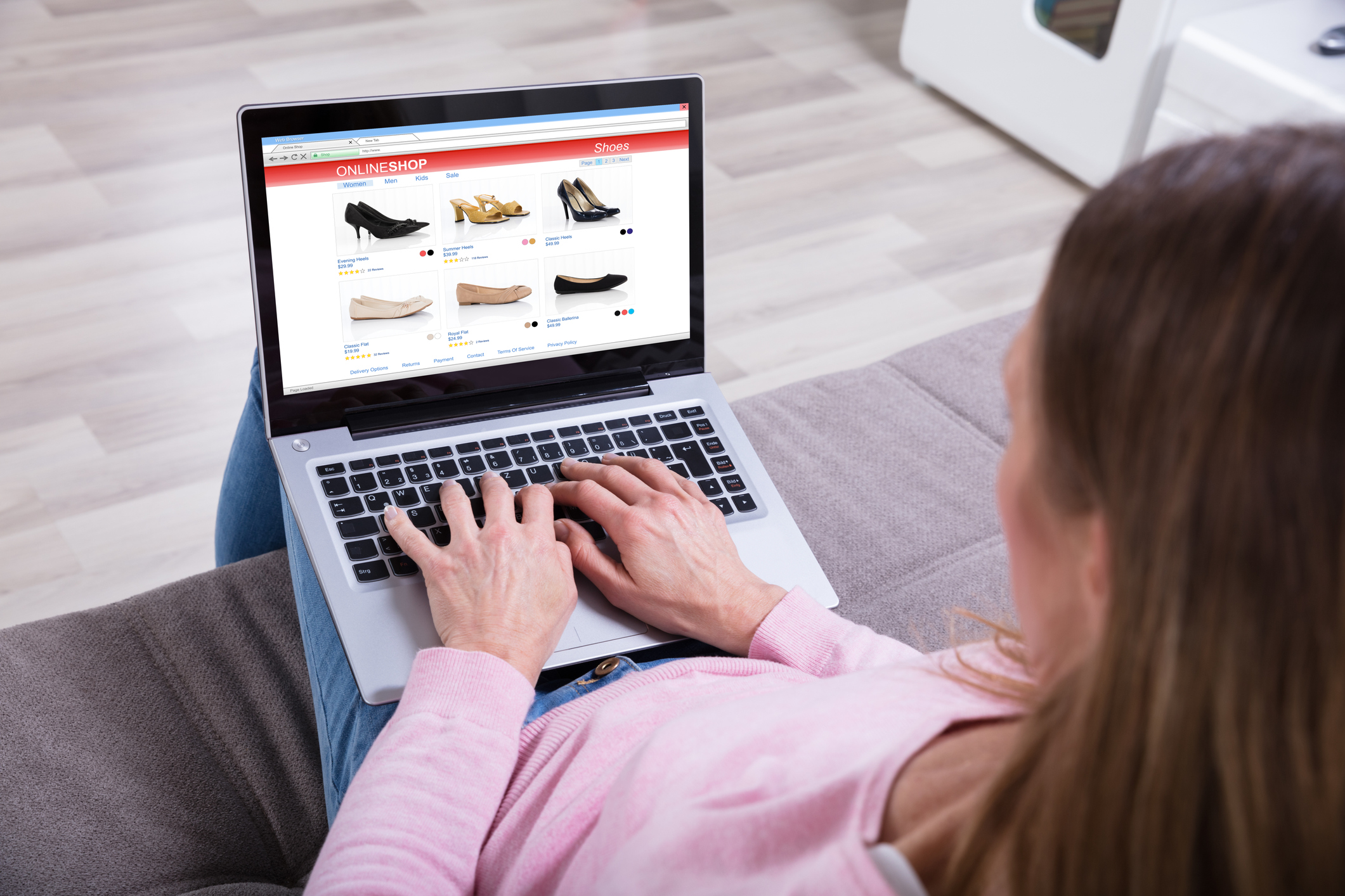 A woman shops online for shoes.
