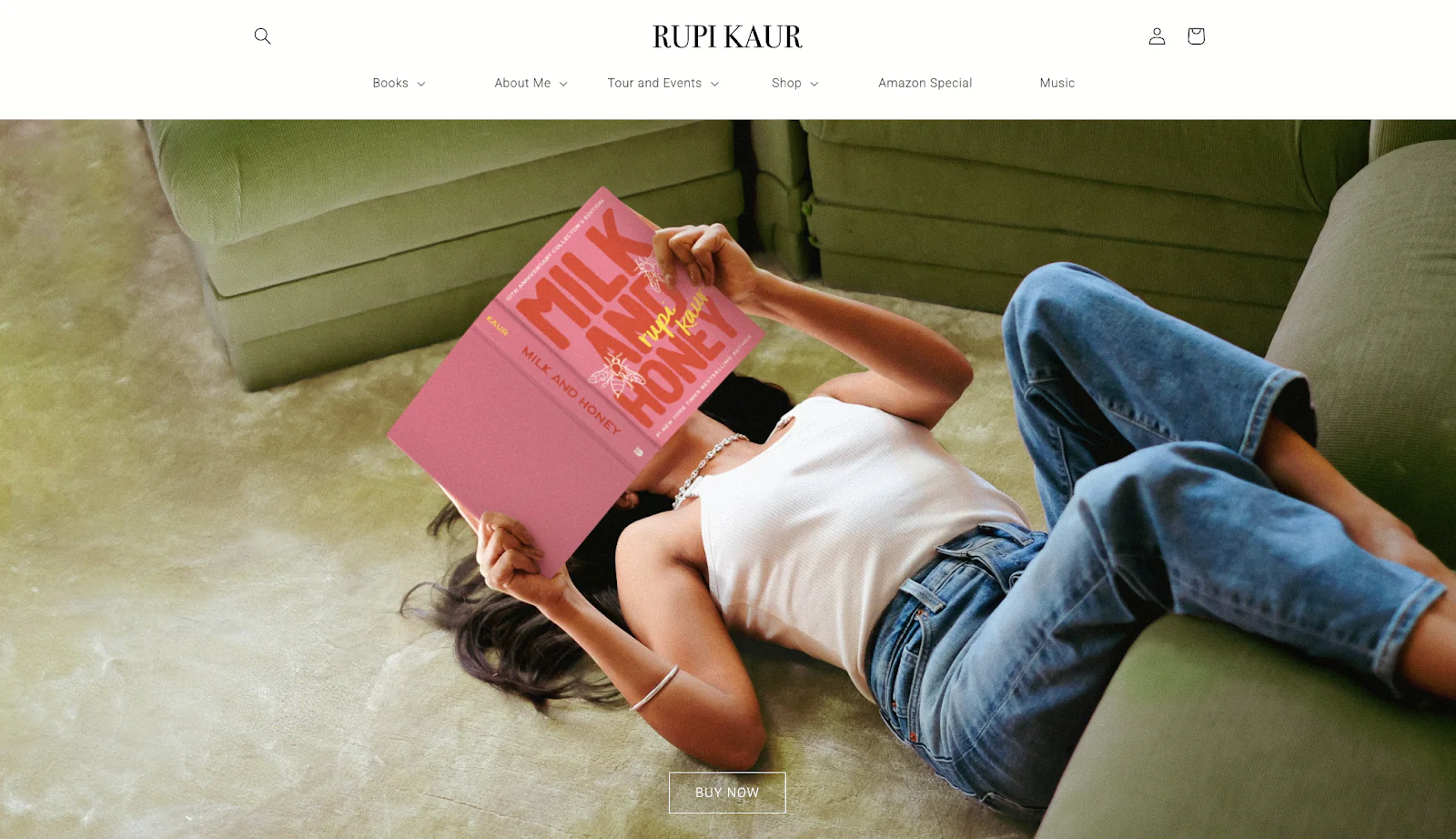 The homepage for poet and performer Rupi Kaur with a picture of her reading on the floor