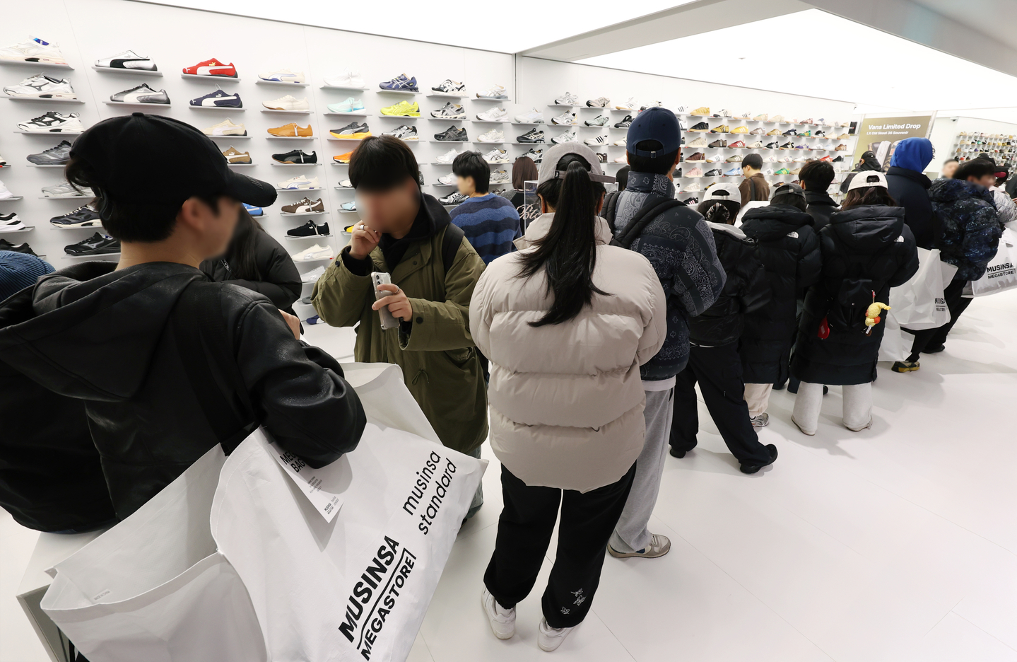 Customers wait in line at a Musinsa Megastore inside I'Park Mall in Yongsan, central Seoul, on Dec. 11. [YONHAP]