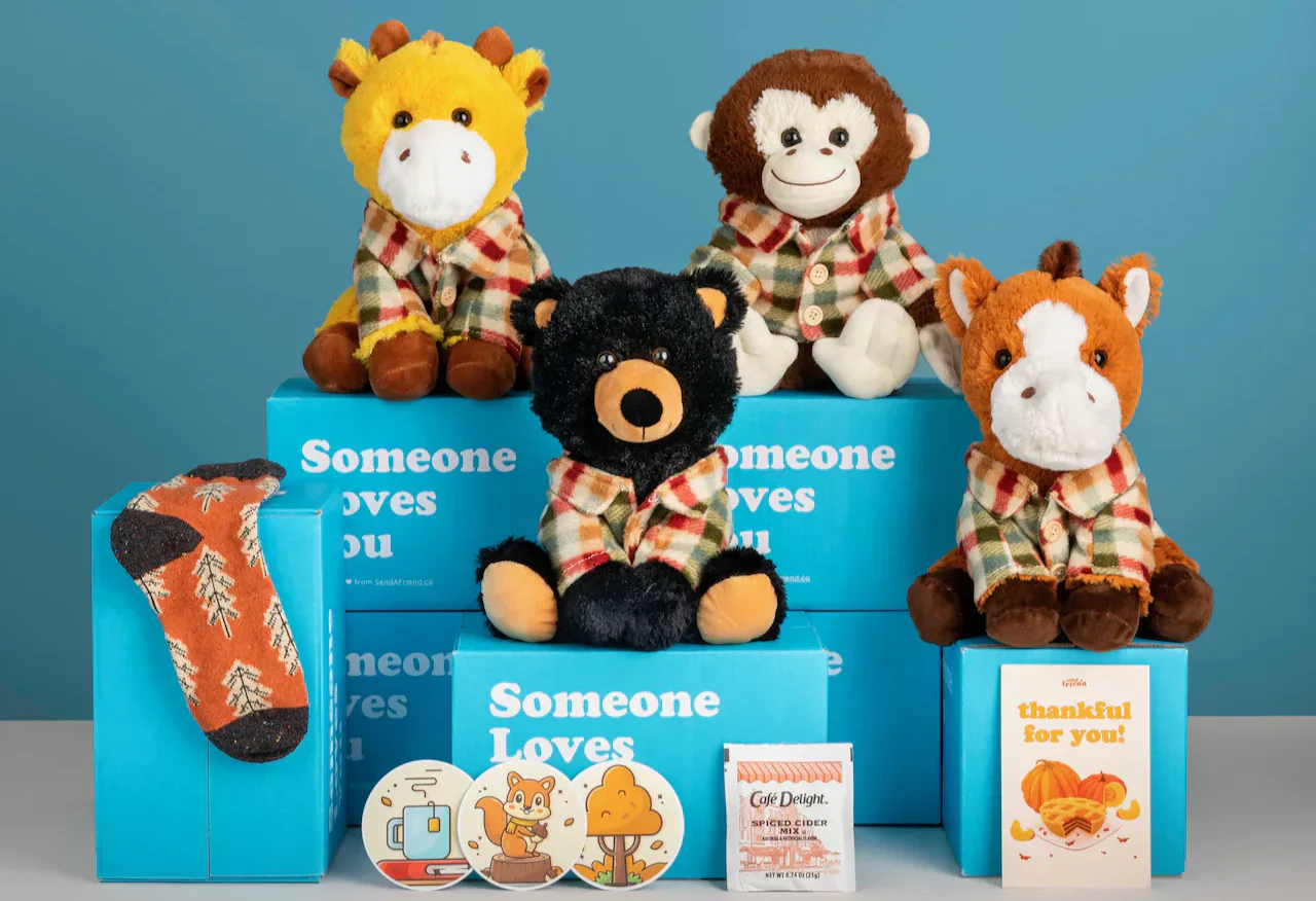 An assortment of stuffed toys sitting on blue product packaging.
