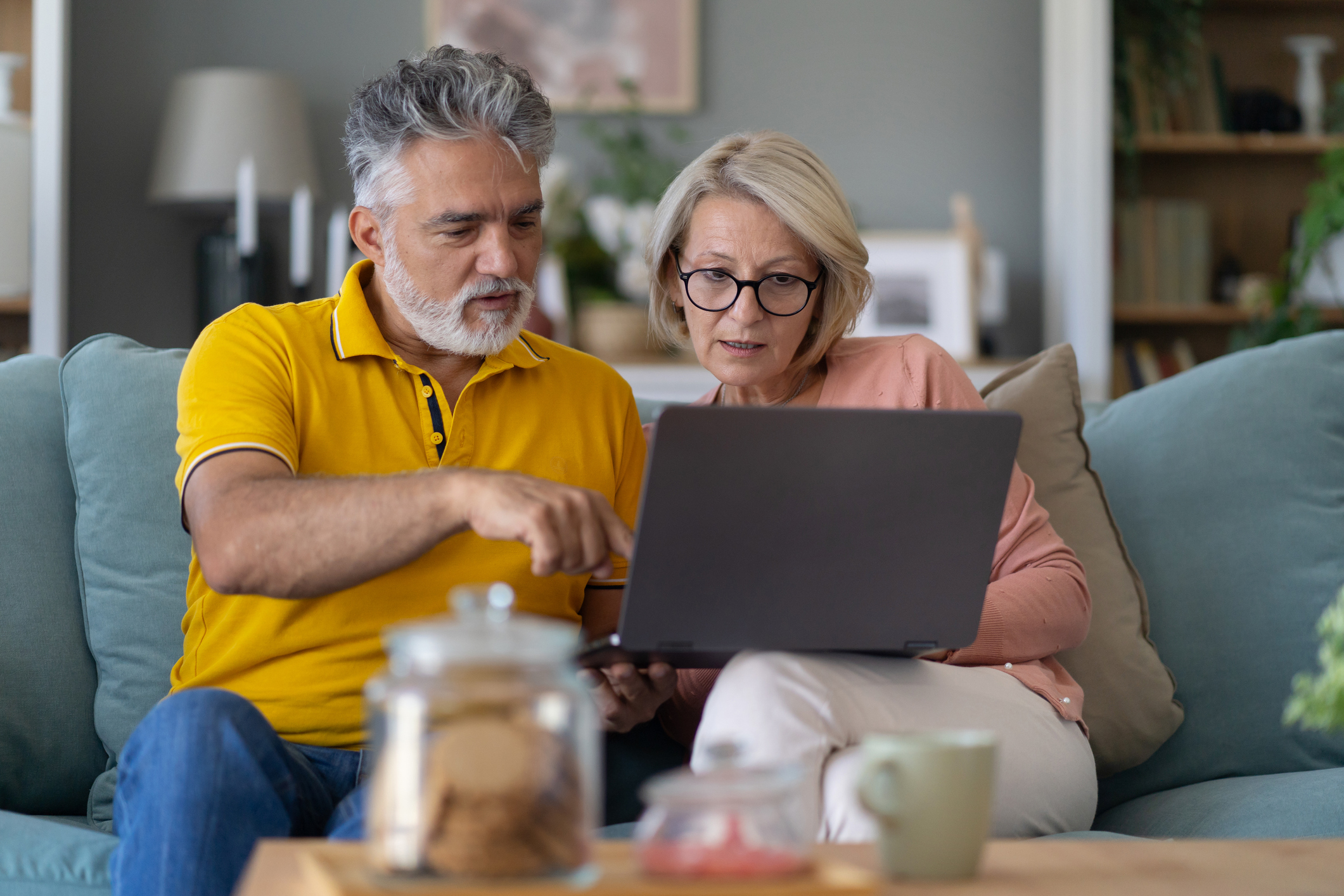 A senior couple comparison shopping on their laptop.