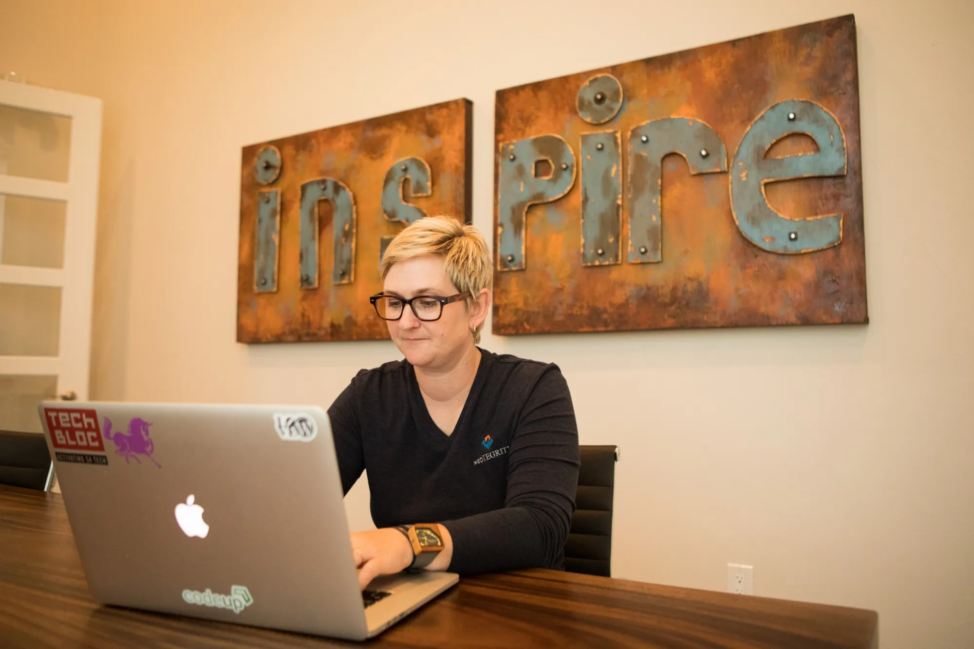 WebTegrity Co-Founder Kori Ashton works in the conference room of WebTegrity.