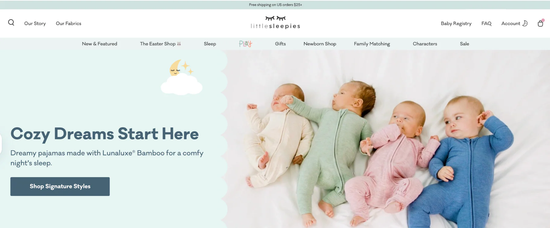 Four babies in colorful, cozy pajamas lie on a white blanket. The pajamas are in pastel shades of pink, green, blue, and cream, promoting comfort.