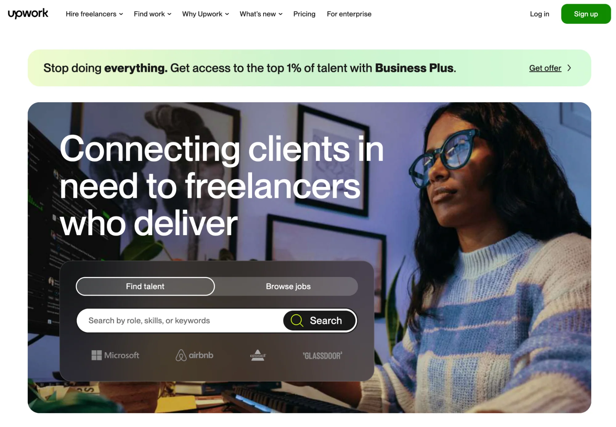 Upwork homepage with a woman at a computer.