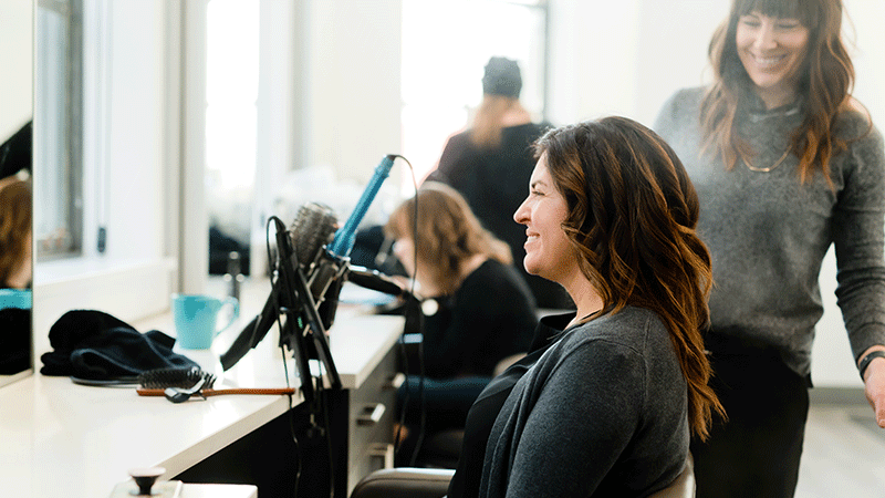 woman smiling at a screen