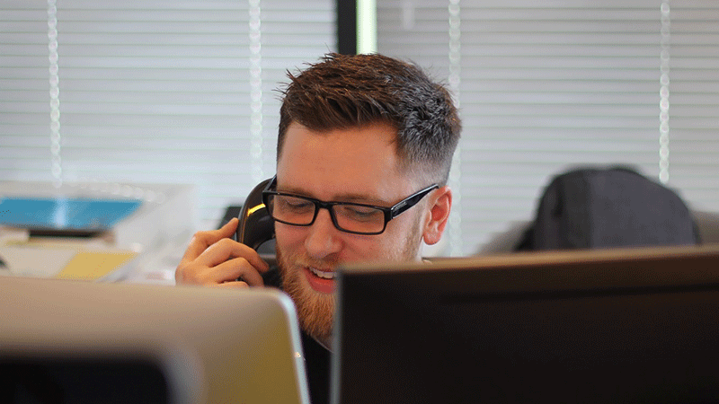 man speaking into a telephone