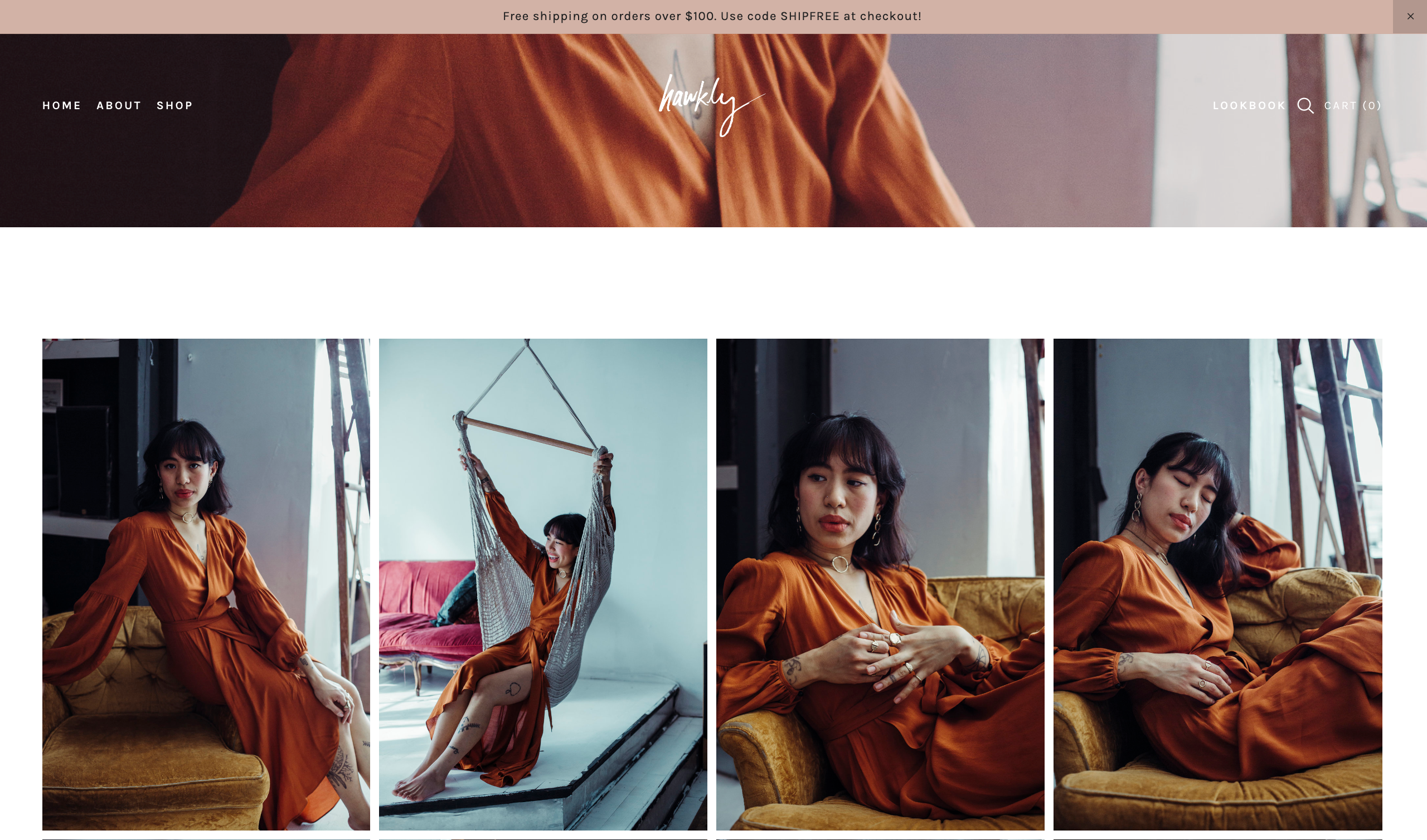 Hawkly Jewelry lookbook featuring model in rust dress showcasing statement jewelry.