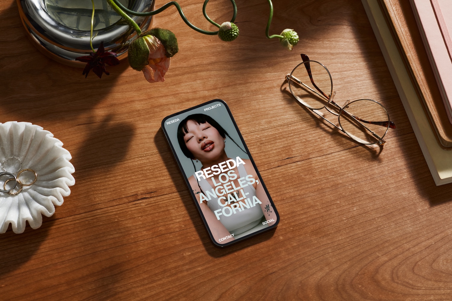 A phone on a table featuring a website designed on Squarespace.